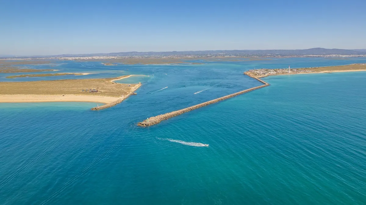 Aerial view of the blue channels, sandbanks and barrier islands of Ria Formosa.