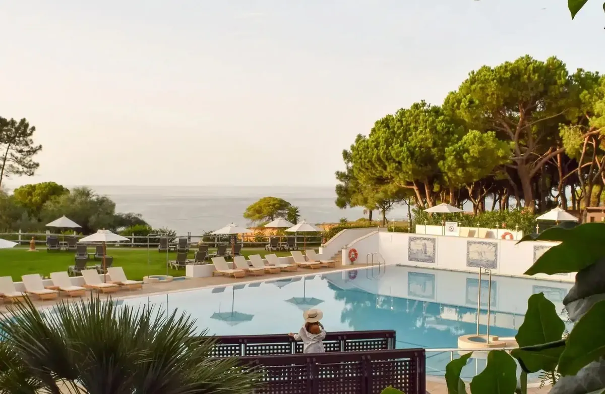 Swimming pool, gardens and pine trees overlooking the sea at Pine Cliffs Resort.