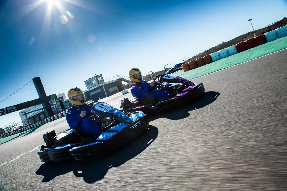 Two drivers racing go-karts at Kartódromo Internacional do Algarve.