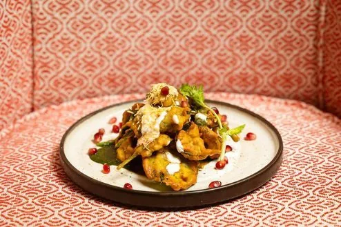 Rohini cuisine presented on a patterned dining table.