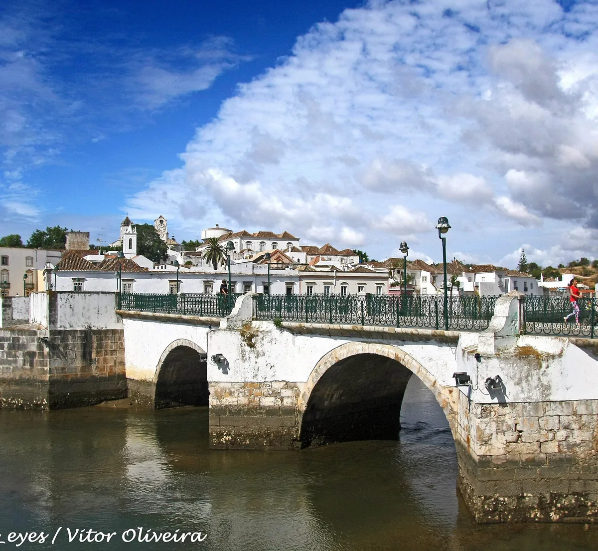 The old stone bridge across the Gilão in Tavira, with the historic town beyond.