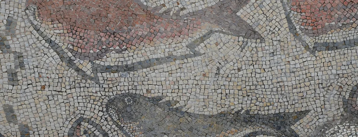 A Roman mosaic at Milreu depicting marine creatures among geometric borders.