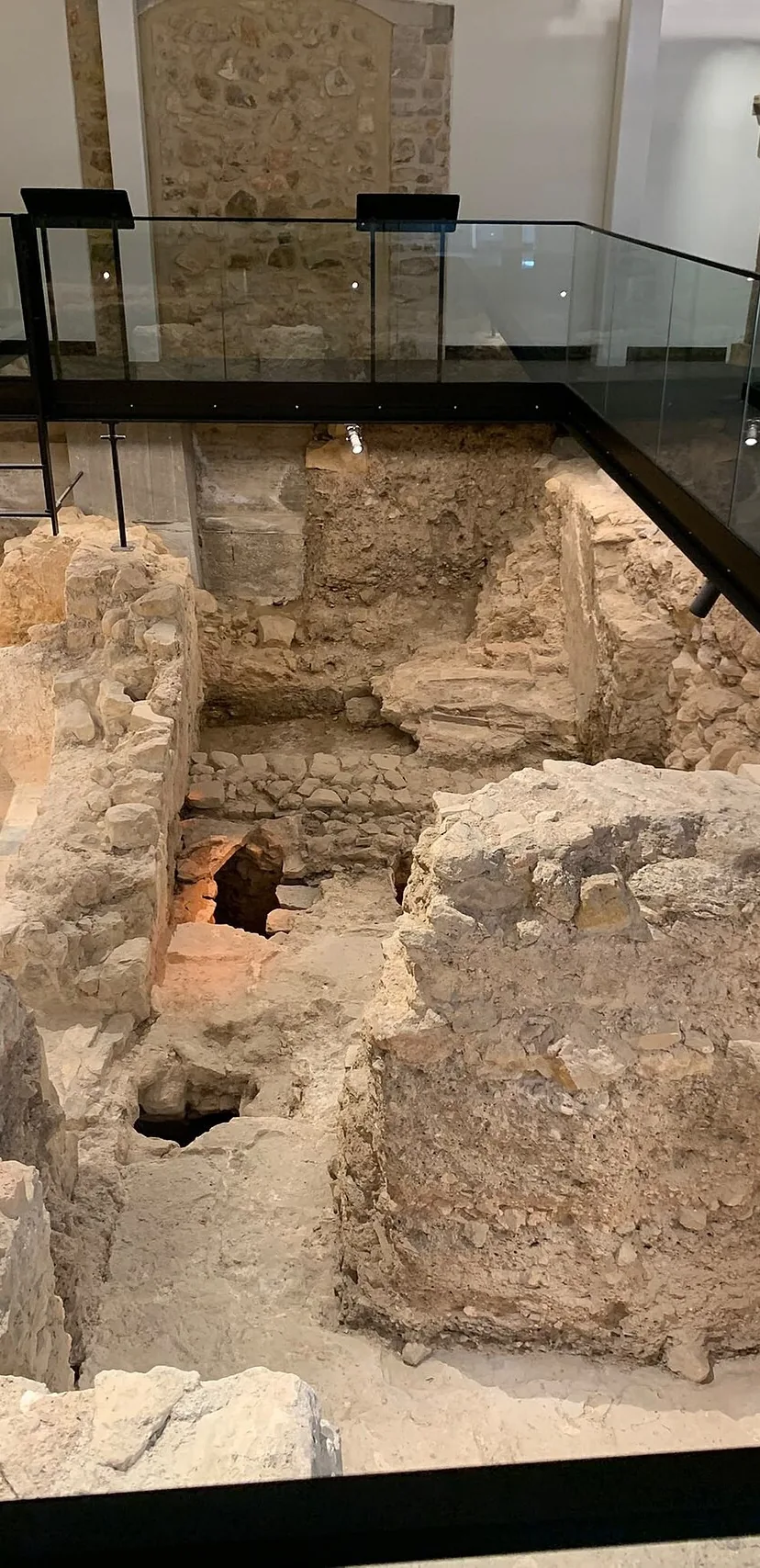 The excavated Islamic Baths in Loulé, with stone walls and a visitor walkway.