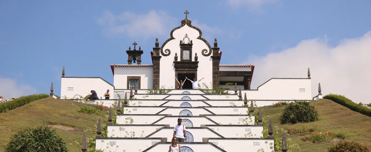 The white chapel and tiled stairway of Nossa Senhora da Paz above Vila Franca do Campo.
