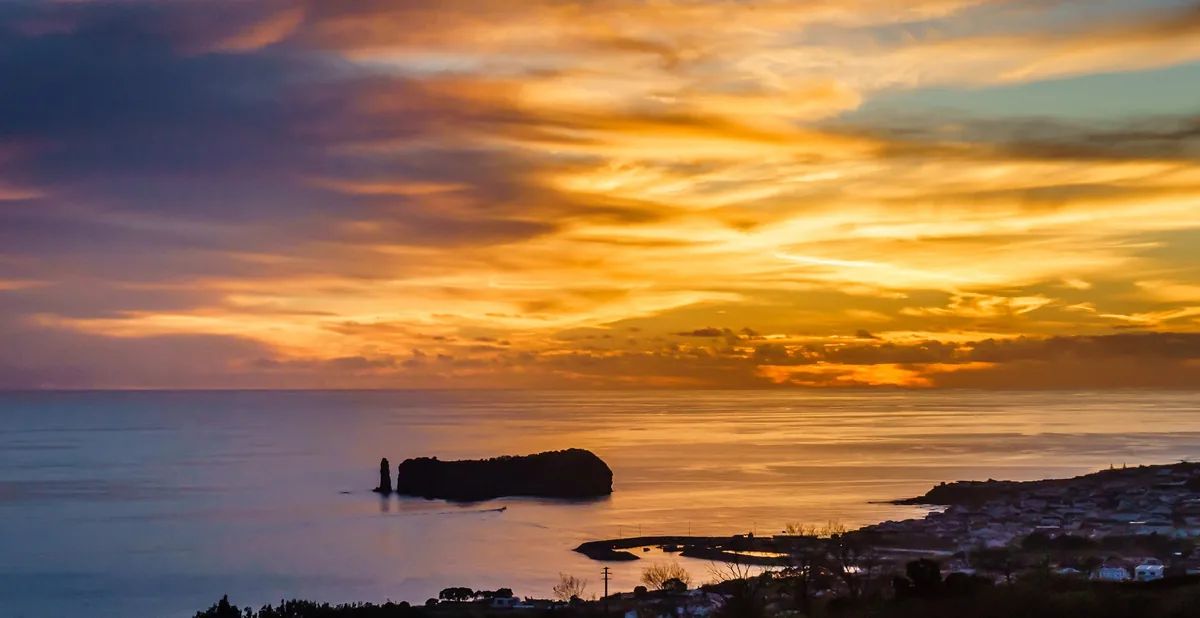 The Atlantic islet off Vila Franca do Campo beneath a vivid sunset sky.
